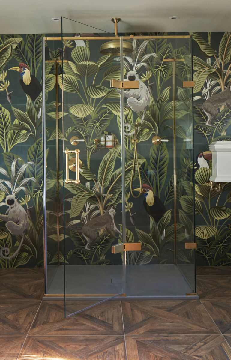 a luxury shower in bathroom with jungle print wallpaper