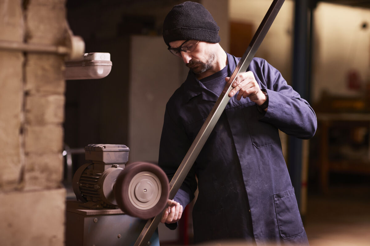 Brushing a man working on a machine