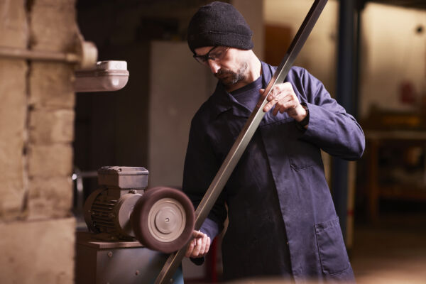 Brushing a man working on a machine