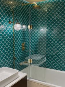 a bath screen in a green bathroom