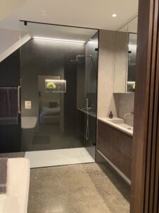 a bathroom with a glass shower and sink