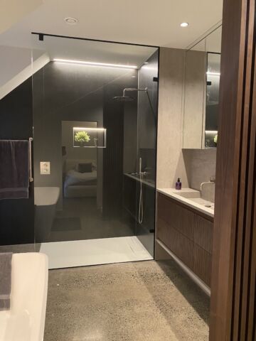 a bathroom with a glass shower and sink