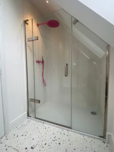 a shower with a pink shower head