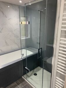 a glass shower door that fits over a bath