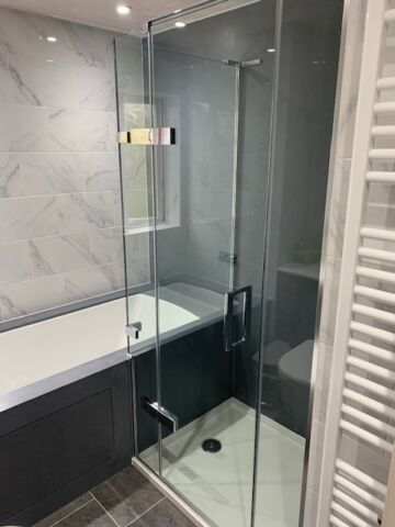 a glass shower door that fits over a bath