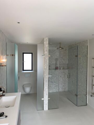 a bathroom with a shower and basin