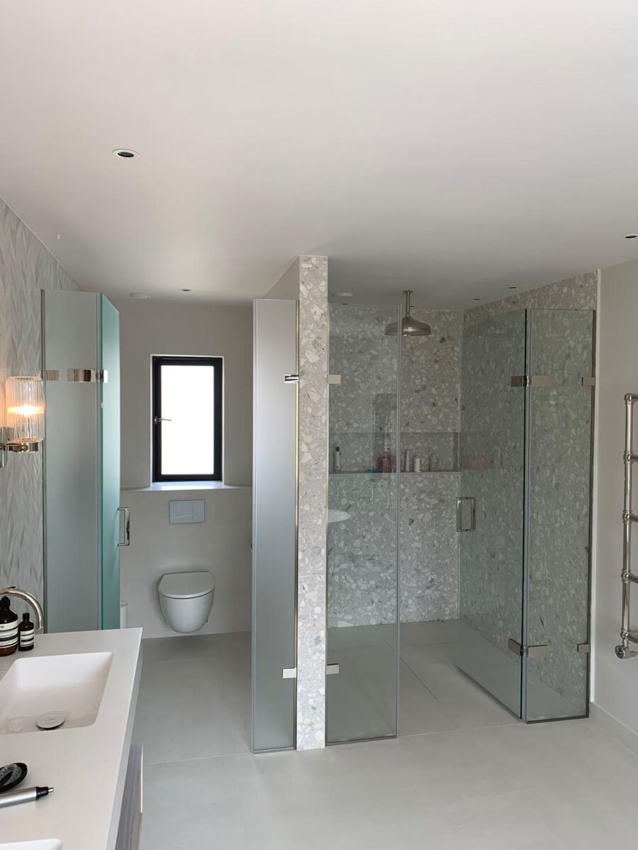 a bathroom with a shower and basin