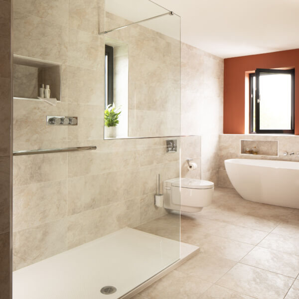 a bathroom with a glass shower and tub