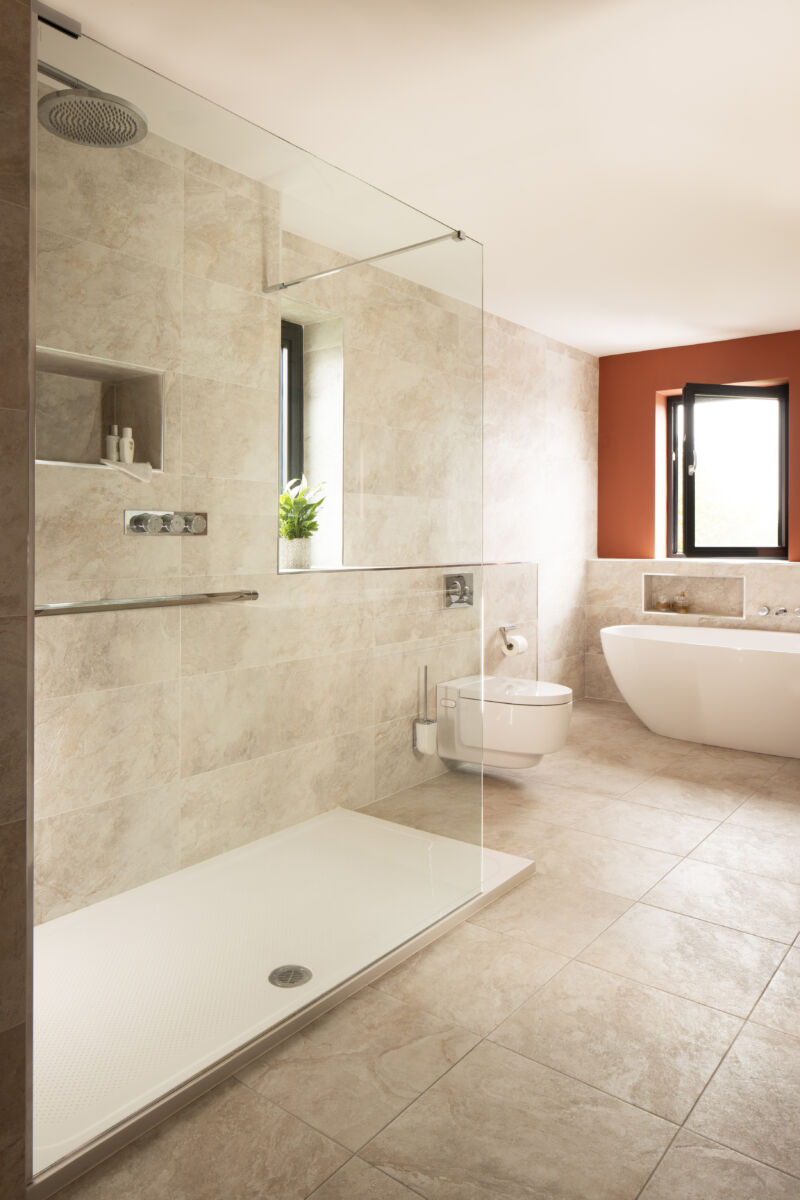 a bathroom with a glass shower and tub